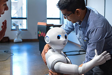 Pepper the robot hugs a student