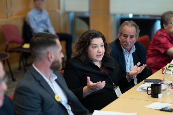a woman speaking in a previous roundtable
