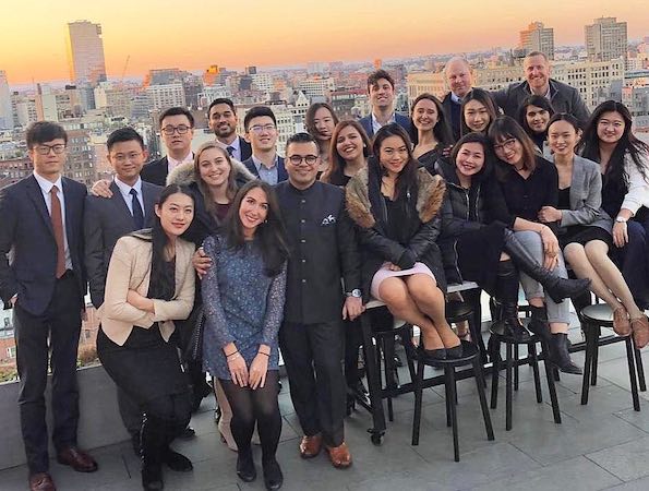 Students on a rooftop with the NYC skyline behind them