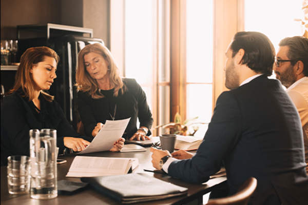 Lawyers converse at a table