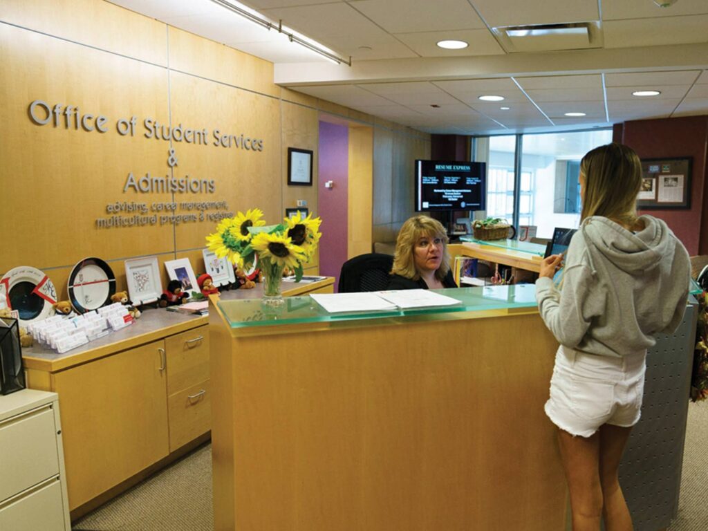 Student talks to a staff member in the Office of Student Services and Admissions