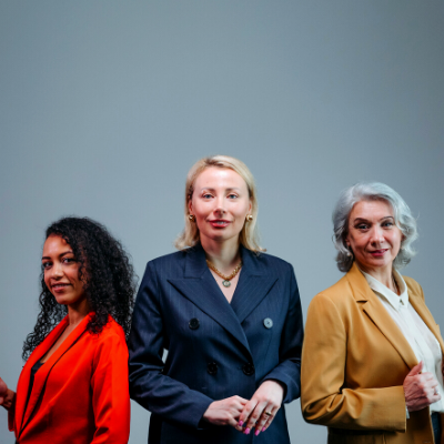 Three women leaders standing side by side.