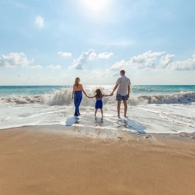 Image of a family together on a beach at a resort