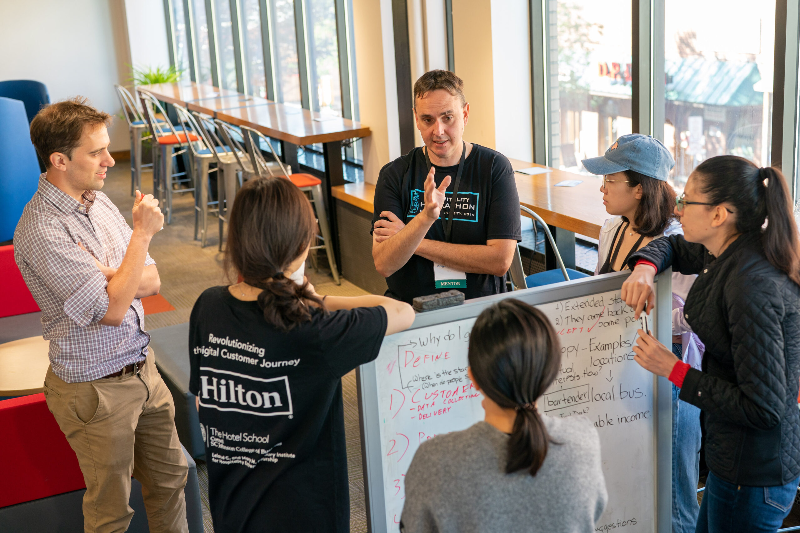 Robert Gregor chats with students at the Hilton Hospitality Hackathon, Leland C. and Mary M. Pillsbury Institute for Hospitality Entrepreneurship, Cornell University.