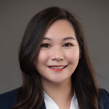 Yongli Zhang smiling and wearing business attire.