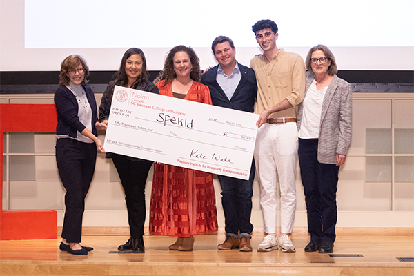 Picture of Jonah Gershon with big check. Also pictured are Dean Kate Walsh, Meli James, Diana Dobin, Tyler Carrico, and Linda Canina.