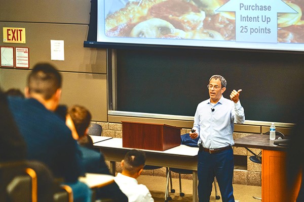 Domino's CEO Russell Weiner '90 speaks at a marketing class