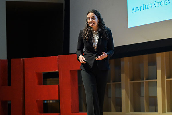 A woman dressed in businss attie speaking on stage.