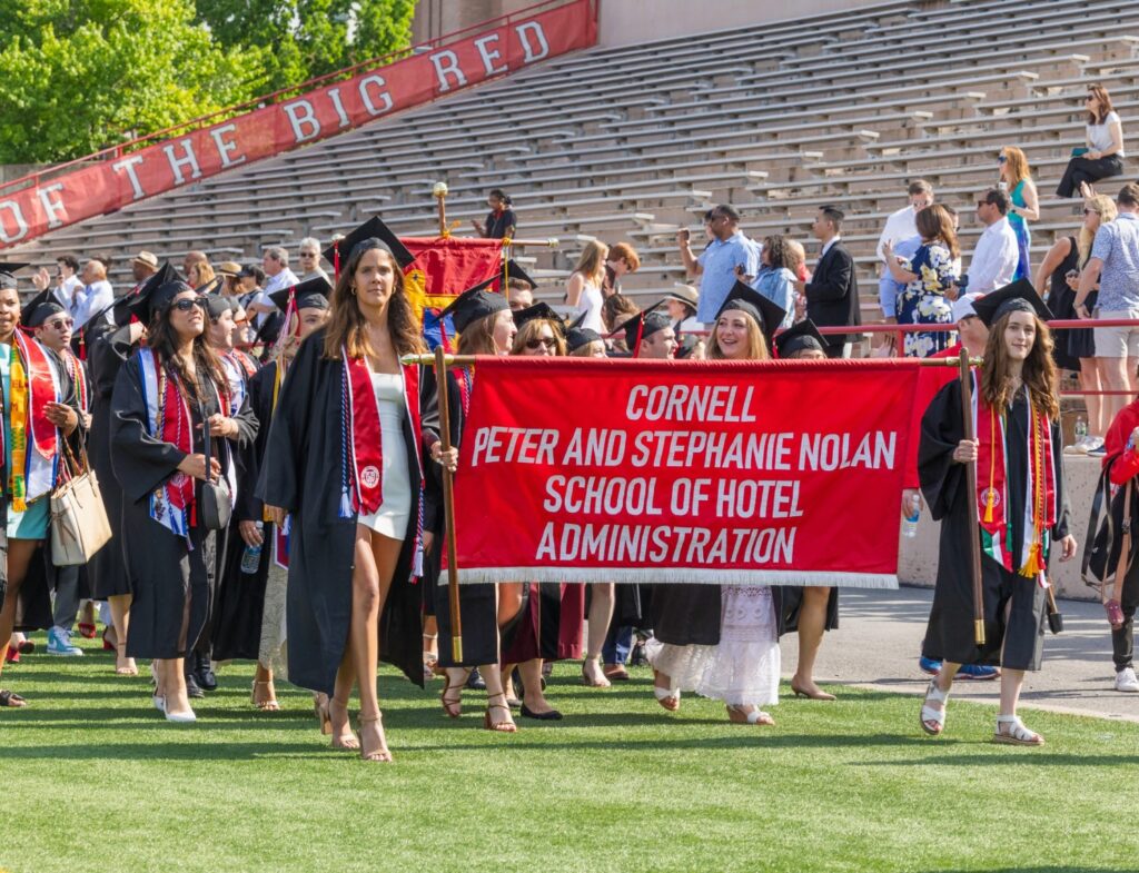 Nolan School banner and graduates procession