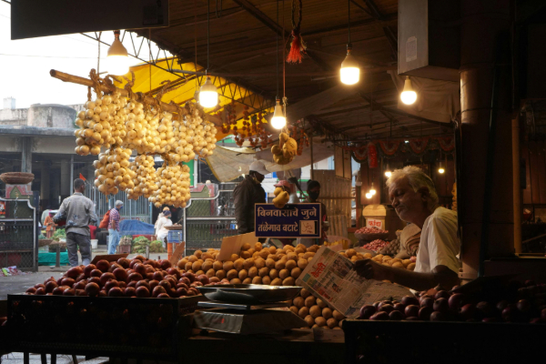 Image of an elderly gentleman selling goods at an outdoor market