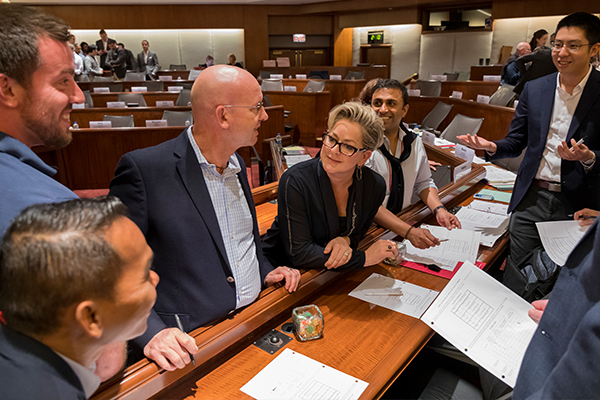 A group of people working together in a classroom.