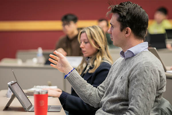 A person speaking during a class discussion.