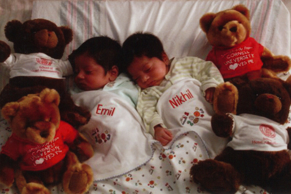Emil and Nikhil as infants surrounded by Cornell bears