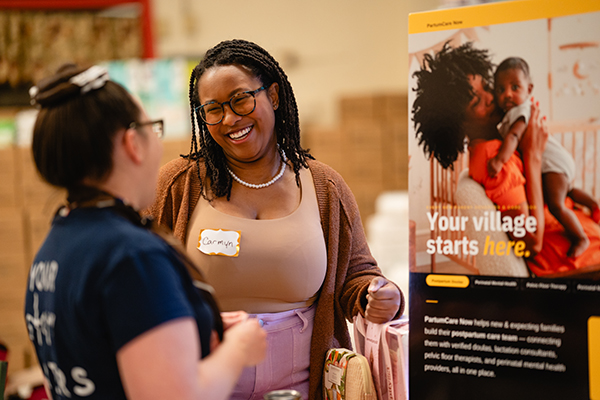Carmyn Polk presents PartumCare Now to an attendee of the family resources fair